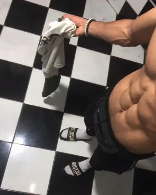 Góc chụp trên sàn caro, V line rõ, outfit tối màu nhìn gọn và lực